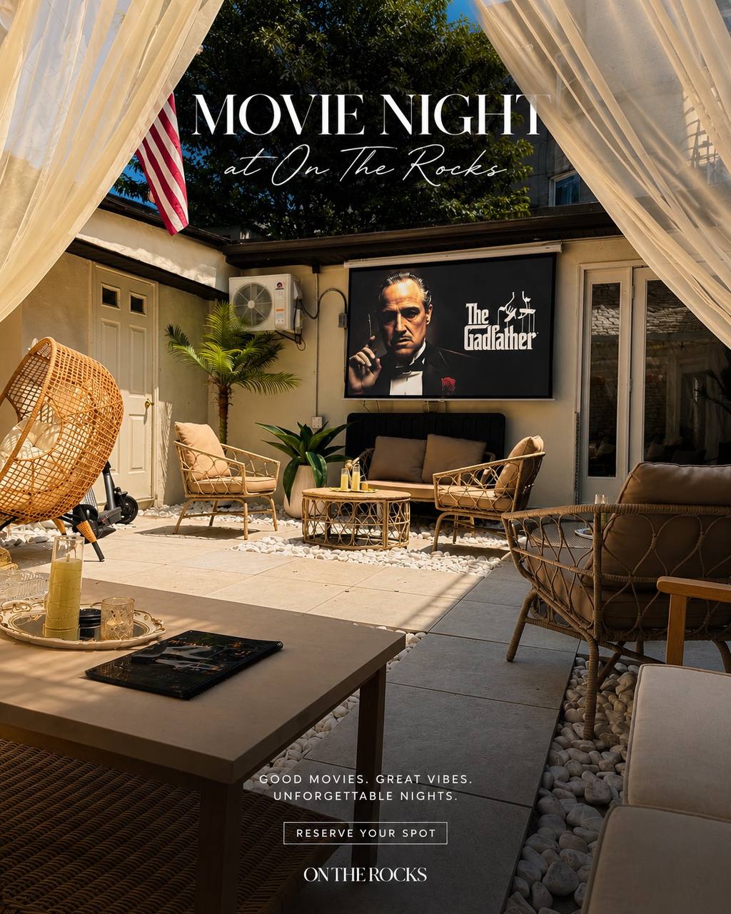 Outdoor movie night at On The Rocks with screen, lounge seating, and string lights